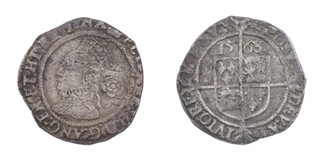 United Kingdom, Elizabeth I, 1563 silver Threepence (third issue), 19mm, 1.5g. Obv: Ornate crowned bust, left, rose behind head / Rev: Square shield of arms on long cross fourche dividing the inscription. S.2565, F. 