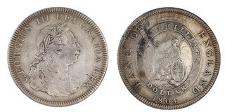 United Kingdom, George III, 1804 silver one Dollar, 41mm, 26.6g. Obv: Laureate and draped bust of George, right / Rev: Britannia seated, left, within a garter surmounted by a castellated crown. S.3768, F. 