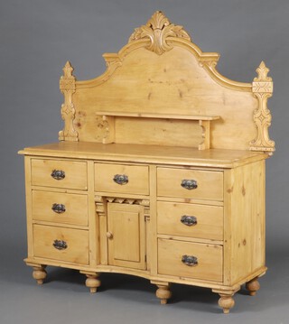 A 19th Century stripped and polished pine chiffonier sideboard with raised associated back fitted a shelf, the base fitted 3 drawers above cupboard flanked by 4 short drawers, raised on bun feet 170cm h x 151cm w x 53cm d 