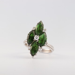 A white gold, testing as 18ct, tourmaline and diamond ring, the 4 Navette shaped green tourmalines 3.4ct, the 5 brilliant cut diamonds 0.20ct, size N, 6 grams 