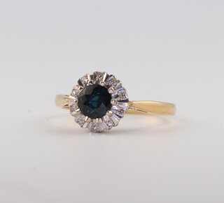 An 18ct yellow gold sapphire and diamond cluster ring, the centre stone 0.7ct, the brilliant cut diamonds 0.05ct, size L, 3 grams