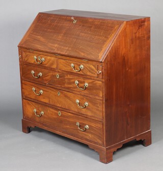 A Georgian mahogany bureau with fall front revealing drawers, cupboard and pigeon holes, the base fitted 3 short and 3 long drawers with brass swan neck drop handles, raised on bracket feet 104cm h x 101cm w x 53cm d  