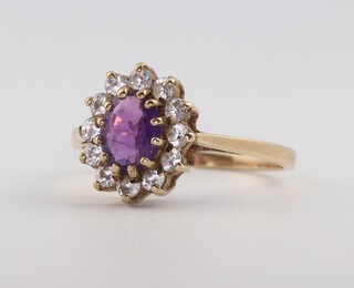 A 9ct yellow gold oval amethyst and paste set ring, the amethyst 0.75ct, size M 1/2, 1.9 grams 