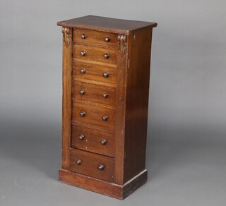 A Victorian oak Wellington chest of 7 drawers with turned handles, raised on a platform base 102cm h x 48cm w x 34cm d 