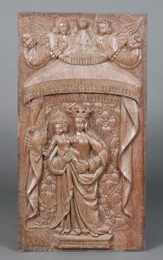 A 17th Century carved oak panel depicting the standing Virgin Mary and infant Christ holding a bird 69cm h x 36cm w 