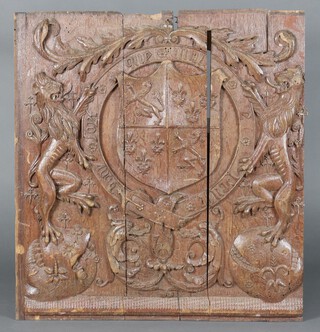 A 17th Century carved oak panel decorated a coat of arms, 89cm x 82cm, in 3 sections 