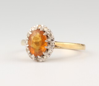 An 18ct yellow gold oval citrine and diamond cluster ring, the centre stone 1ct, the 12 brilliant cut diamonds each approx 0.01ct, 3.5 grams, size 0 1/2 