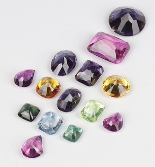 A brilliant cut amethyst stone 2cm and a small quantity of polished semi-precious stones 