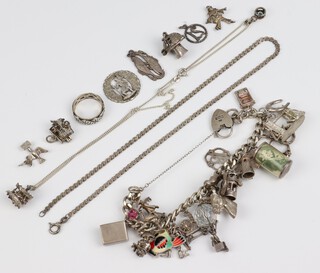 A silver charm bracelet with extra charms, 116 grams 