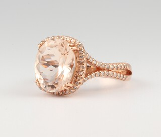 A 14ct rose gold morganite and diamond cluster ring, the centre stone approx. 4.1ct, the diamonds approx. 0.47ct, 5.8 grams, size N 