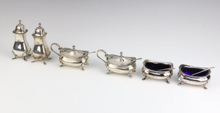 A six piece silver condiment set on pad feet Birmingham 1955, 124 grams, complete with blue glass liners 