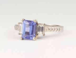 A white gold 14ct tanzanite and diamond ring, the emerald cut stone approx. 1.8ct, the baguette and brilliant cut diamonds approx. 0.6ct., size Q 1/2, 4.2 grams 