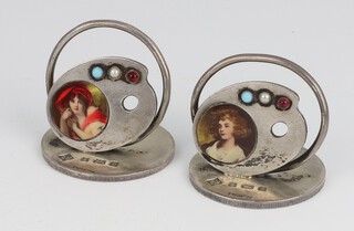 A pair of Edwardian novelty silver and enamelled menu holders in the form of an artists pallet with enamelled portraits and turquoise, garnet and pearl mounts, Birmingham 1905, maker Martin Hall and Company, 48 grams, 4cm 