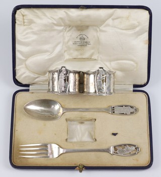 A Victorian silver, Mappin & Webb christening set comprising fork, spoon and napkin ring, London 1865 and 1866, decorated with nursery rhyme characters (Dick Whittington ?),  in a fitted case 130 grams together with a matching napkin ring London 1865