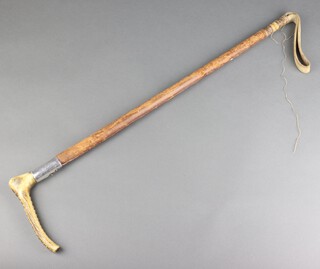 A white metal mounted riding crop 