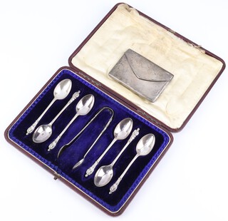 A George V silver card case in the shape of an envelope Birmingham 1911 66 grams, together with a cased set of 6 silver apostle coffee spoons and nips Sheffield 1920, cased 100 grams 