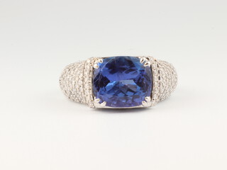 An 18ct white gold cushion cut tanzanite and diamond ring, the centre stone 3ct, 10.1 grams, size Q