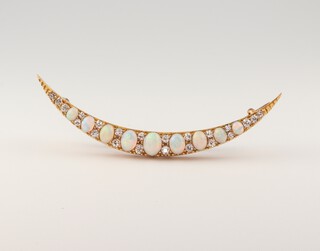 A yellow gold, testing as 18ct, opal and diamond crescent brooch, the opals 2.6ct, the diamonds 0.5ct, 60mm, 5.3 grams 