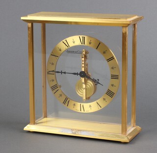 Jaeger-LeCoultre, a skeleton style clock with gilt chapter ring and Roman numerals, contained in a gilt metal and glass case 17cm h x 15cm w x 6cm d 