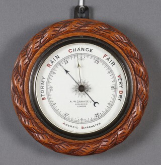 An aneroid barometer with porcelain dial marked A W Gamage Ltd of Holborn 5cm x 19cm 