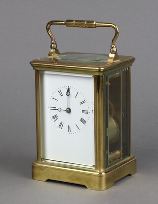 A 19th Century French 8 day striking carriage clock with 6cm dial, Roman numerals, contained in a gilt metal case 13cm x 9cm x 8cm, complete with key 