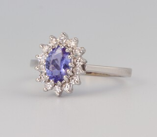 A 9ct white gold oval tanzanite and diamond cluster ring the centre stone 0.8ct, the brilliant cut diamonds 0.2ct, 2.9 grams, size N 