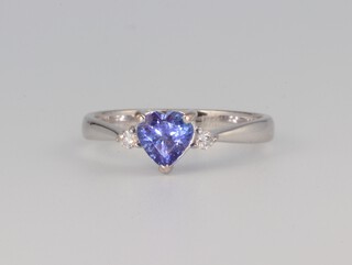 An 18ct white gold heart shaped tanzanite and diamond ring, the centre stone 1ct, the brilliant cut diamonds 0.06ct, size P 1/2, 3.7 grams 