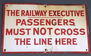 Of railway interest, a red and white enamelled sign "The Railway Executive, Passengers  Must Not Cross The Line Here" 41cm x 66cm 