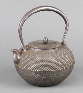 A Japanese cast iron teapot with swing handle 11cm x 17cm 