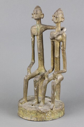 A Benin style gilt bronze figure of a seated lady and gentleman on an oval base 36cm h x 16cm w x 14cm d