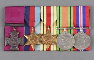 A group of 5 medals comprising facsimile Victoria Cross, 1939-45 Star, Africa Star, Defence and War medal, cork mounted 