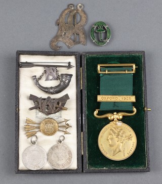 A gilt metal Grand National Archery Society medal with bar Oxford 1925 and 3 archery badges 