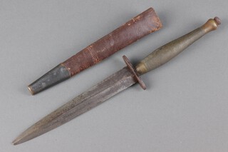 A World War II second pattern Fairbairn-Sykes Wilkinson Sword fighting dagger, the blade etched Wilkinson Sword London and FS Fighting Knife complete with leather scabbard and brass grip 