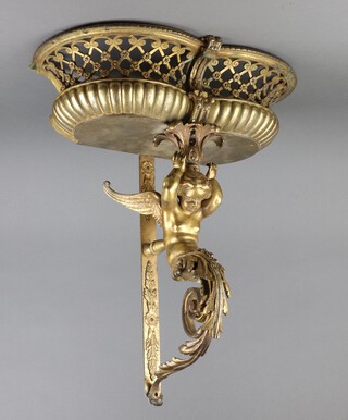 A 19th Century gilt metal shaped wall bracket supported by a cherub with pierced basket 59cm h x 49cm w x 25cm d  