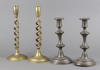 A pair of Victorian spiral turned brass candlesticks 30cm h x 12cm diam. together with a pair of 18th/19th Century pewter candlesticks 24cm x 11cm (bases misshapen) 