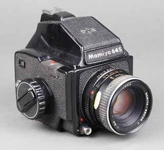 A Mamiya 645 medium format camera no.M645J with Mamiya-Sekor C 1:2.8 F=80mm no.90352 lens, the base of the camera marked J104541, contained in a Nikon gadget box 