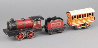 An O gauge tin plate model locomotive and tender together with an O gauge clockwork First Class carriage