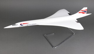 A 14/100 scale model of a Concorde with British Airways insignia on a chrome support 63cm long, boxed  