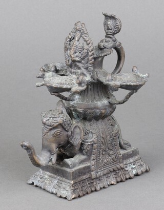 An Indian bronze oil lamp in the form of a standing elephant 14cm x 10cm x 6cm 