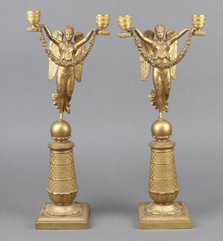 An impressive pair of Empire gilt ormolu twin light candelabrum supported by winged figures of standing ladies, raised on square bases 42cm h x 11cm w x 10cm d 