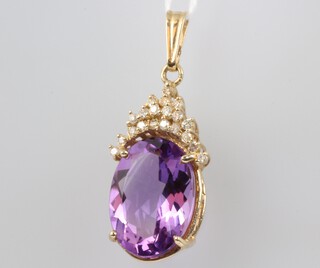 A yellow gold 10ct oval amethyst and diamond pendant, the amethyst 7.8ct, the diamonds approx. 0.4ct, 45mm, 10 grams 