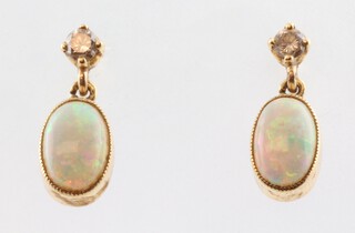 A pair of yellow gold, testing as 9ct, opal and diamond ear drops, the opals 2.5ct, the diamonds 0.20ct, 15mm, 2 grams 