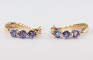 A pair of 14ct yellow gold 3 stone tanzanite and diamond ear clips, the diamonds 0.04ct, the tanzanite 0.4ct, 2.7 grams 