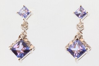 A pair of white gold, testing as 18ct, square tanzanite and diamond ear drops, the tanzanite approx. 1.4ct, the diamonds 0.1ct, 3.6 grams, 17mm 