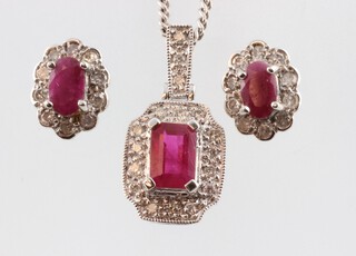 A 9ct white gold ruby and diamond pendant, the rectangular ruby 0.5ct, the brilliant cut diamonds 0.02ct, 18mm, hung on a 9ct chain 46cm, 2.6 grams together with 2 white gold ruby and ear diamond ear studs 2 grams 