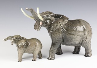 A Beswick figure of an elephant, trunk stretching, large, gloss, by Arthur Gredington no.998 26cm together with a smaller ditto no.974 12cm.