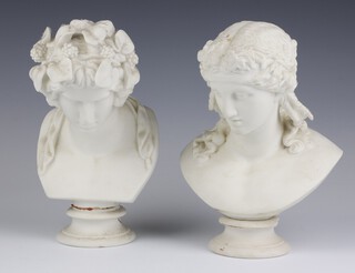 A pair of Victorian Parian busts of a classical lady and gentleman, raised on circular bases 23cm 