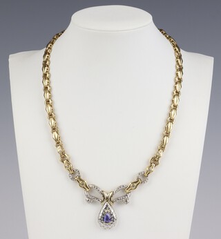 A yellow gold, testing as 14ct, tanzanite and diamond 2 colour necklace, the pear cut tanzanite 1ct, the brilliant cut diamonds approx. 1ct, 45.8 grams gross 