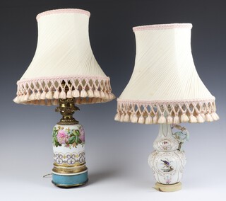 A Paris porcelain oil lamp with floral decoration converted to electricity 32cm and a Victorian Continental porcelain ewer decorated with birds converted to electricity 28cm 