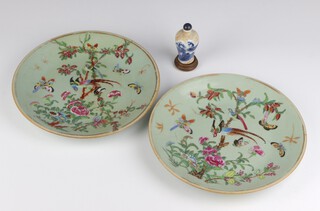 A pair of late 19th Century Chinese Celadon dishes decorated with birds and insects amongst flowers (1 is stuck) and a blue and white scent bottle decorated with figures on a river landscape 8cm (replaced stopper)